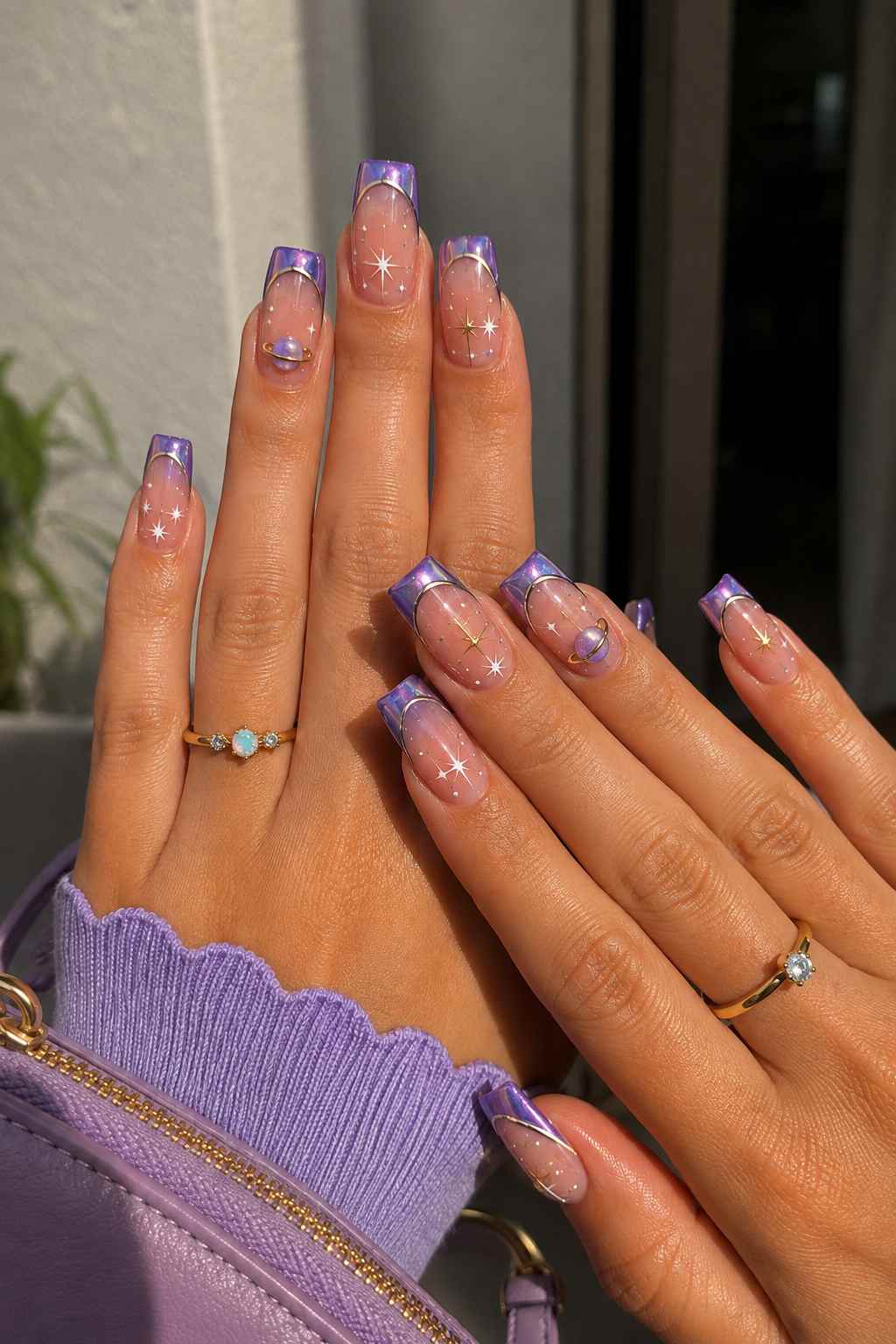 Purple chrome French tip nails with gold Saturn ring and star nail art