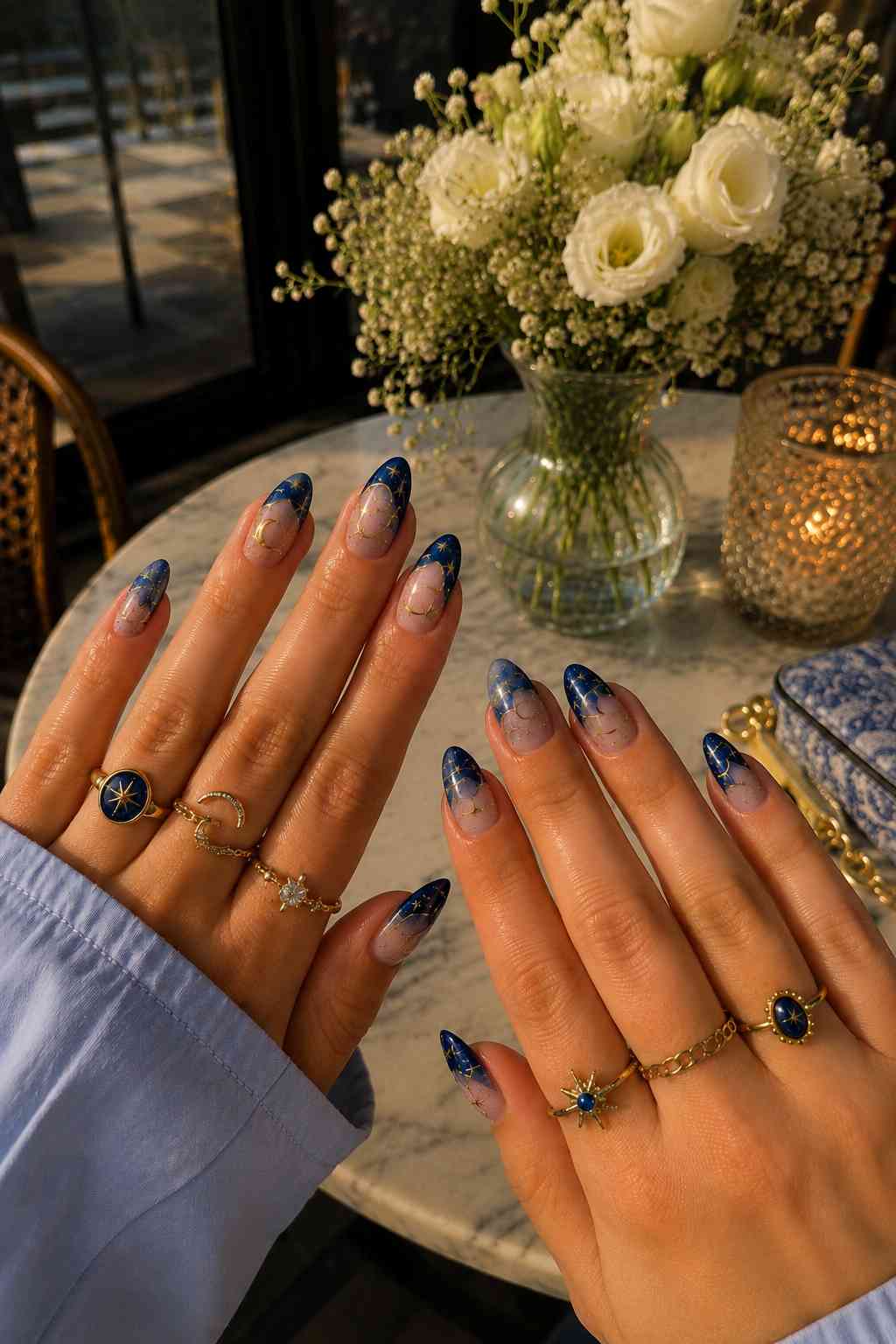 Navy to nude ombré nails with fine gold star and moon nail art