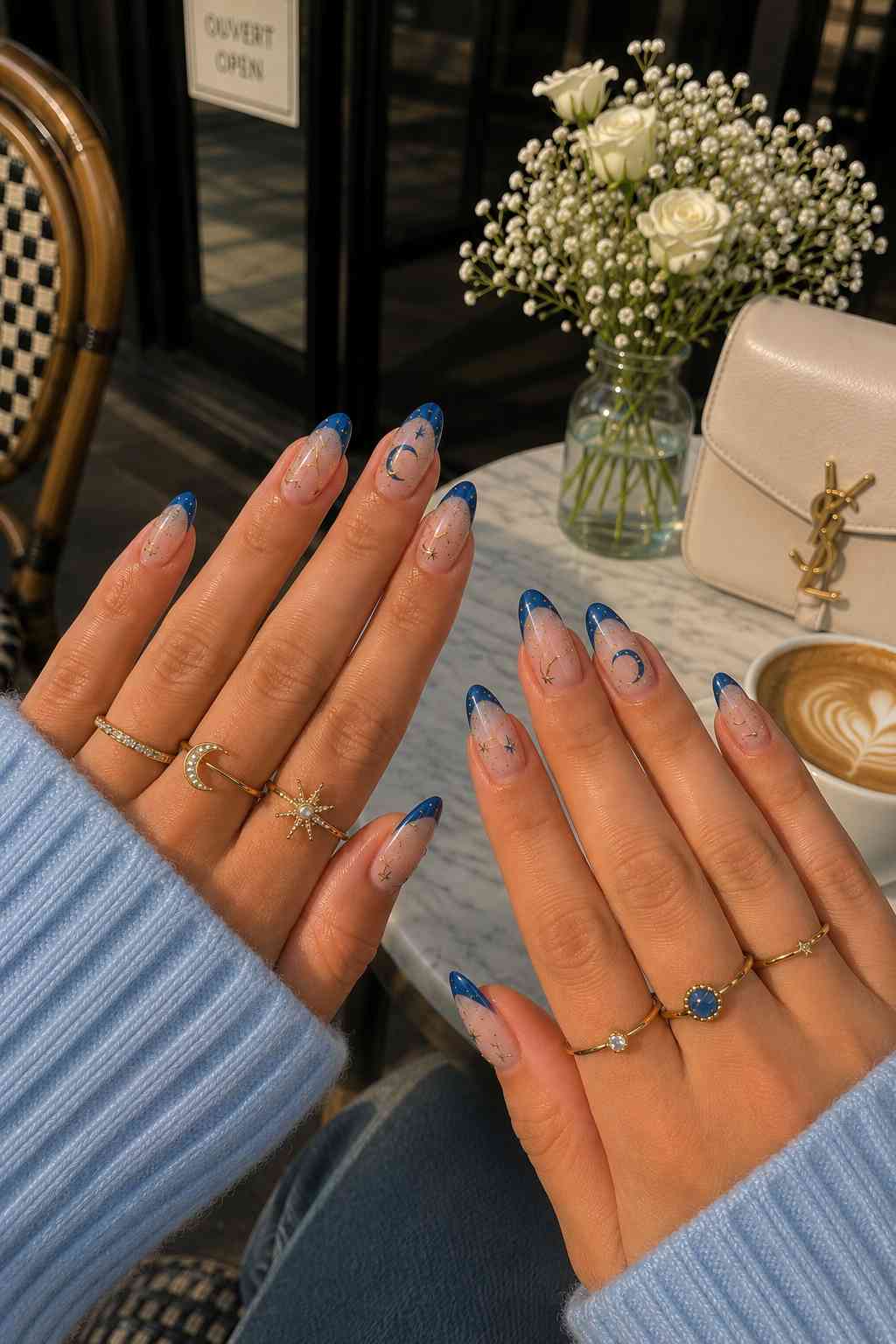 Sapphire blue French tip nails with gold moon phase and star nail art