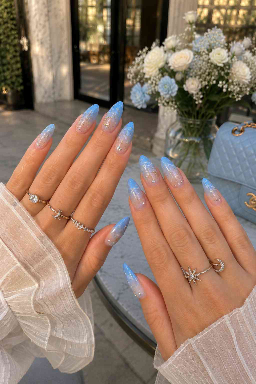 Blue-to-white ombré nails with gold star and moon nail art