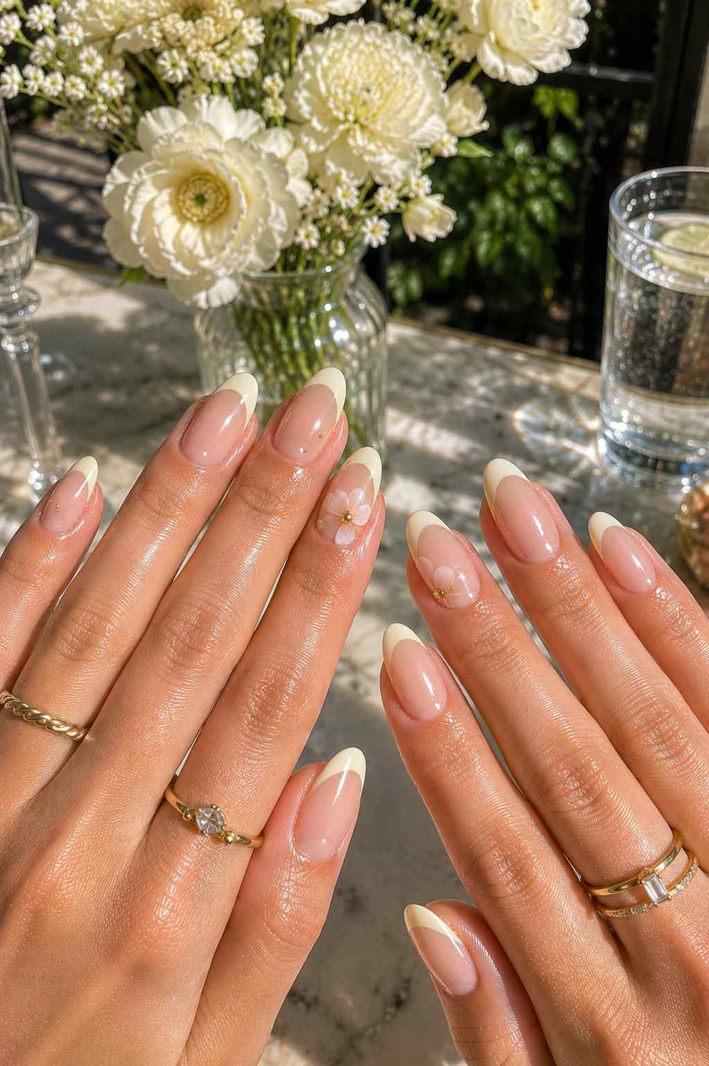 Cream French tip nails with a delicate daisy accent nail