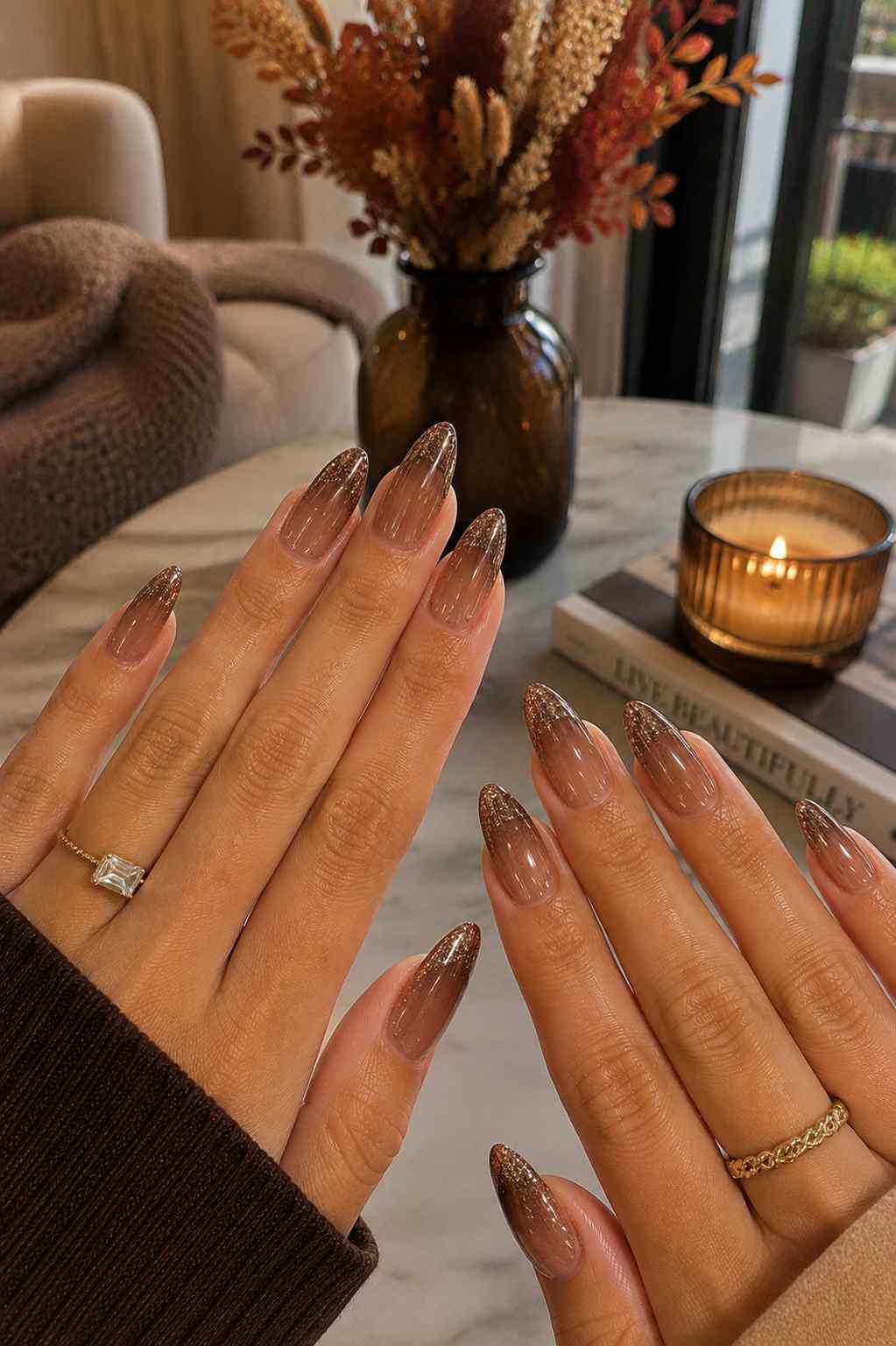 Sheer brown nude nails fading into a shimmery brown glitter French tip