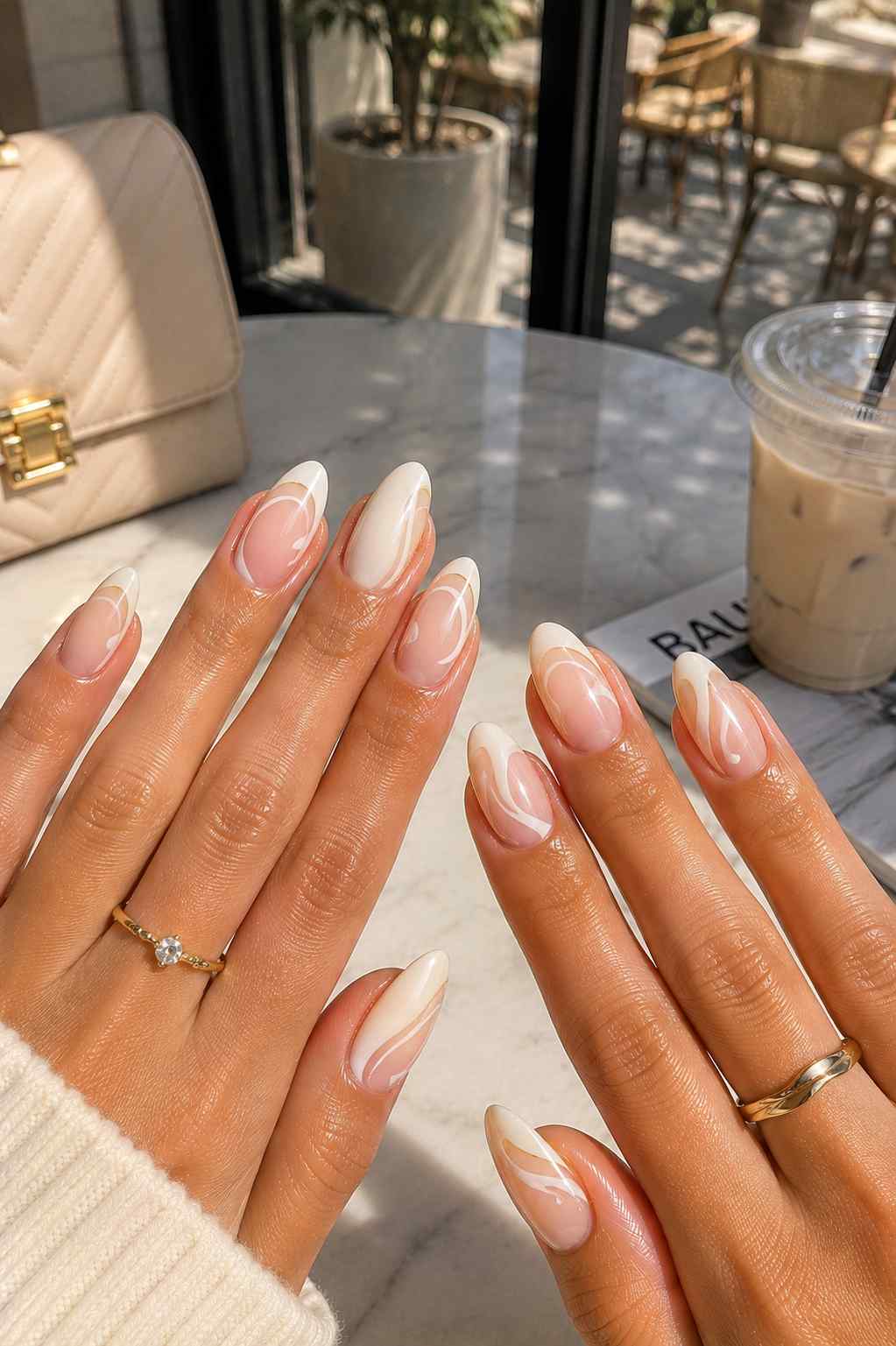 Marbled cream and white swirl nail art on a sheer vanilla base