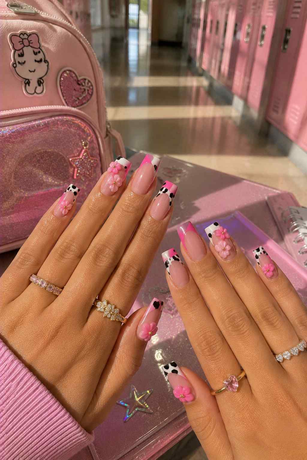 Nude nails with pink and cow print French tips and 3D pink flower accents
