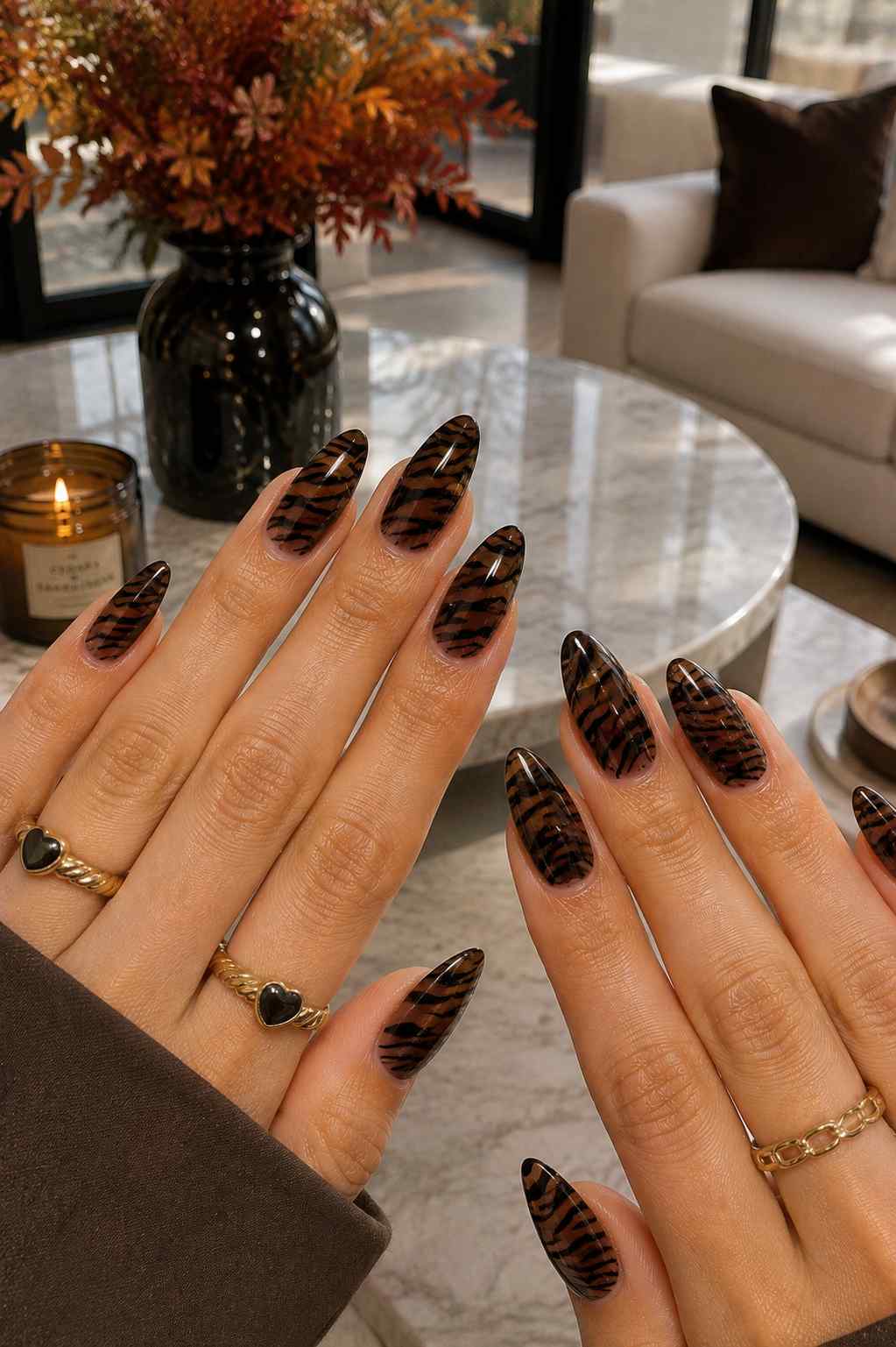 Amber-brown stiletto nails with hand-painted black tiger stripe nail art