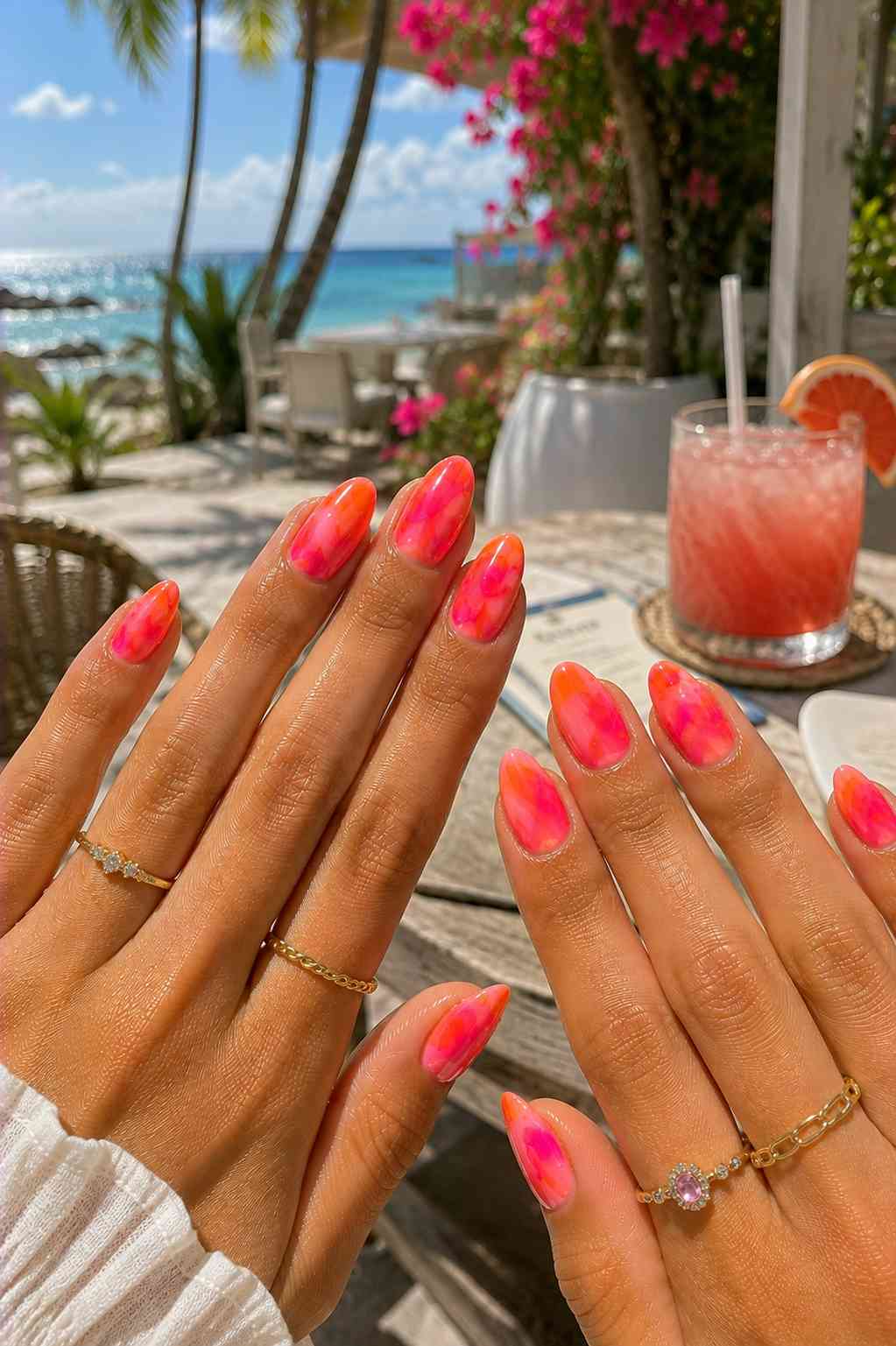 Bold abstract marbled nails in hot pink and orange