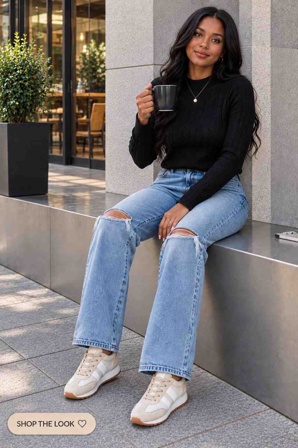 Black cable knit sweater with ripped straight leg jeans and sneakers
