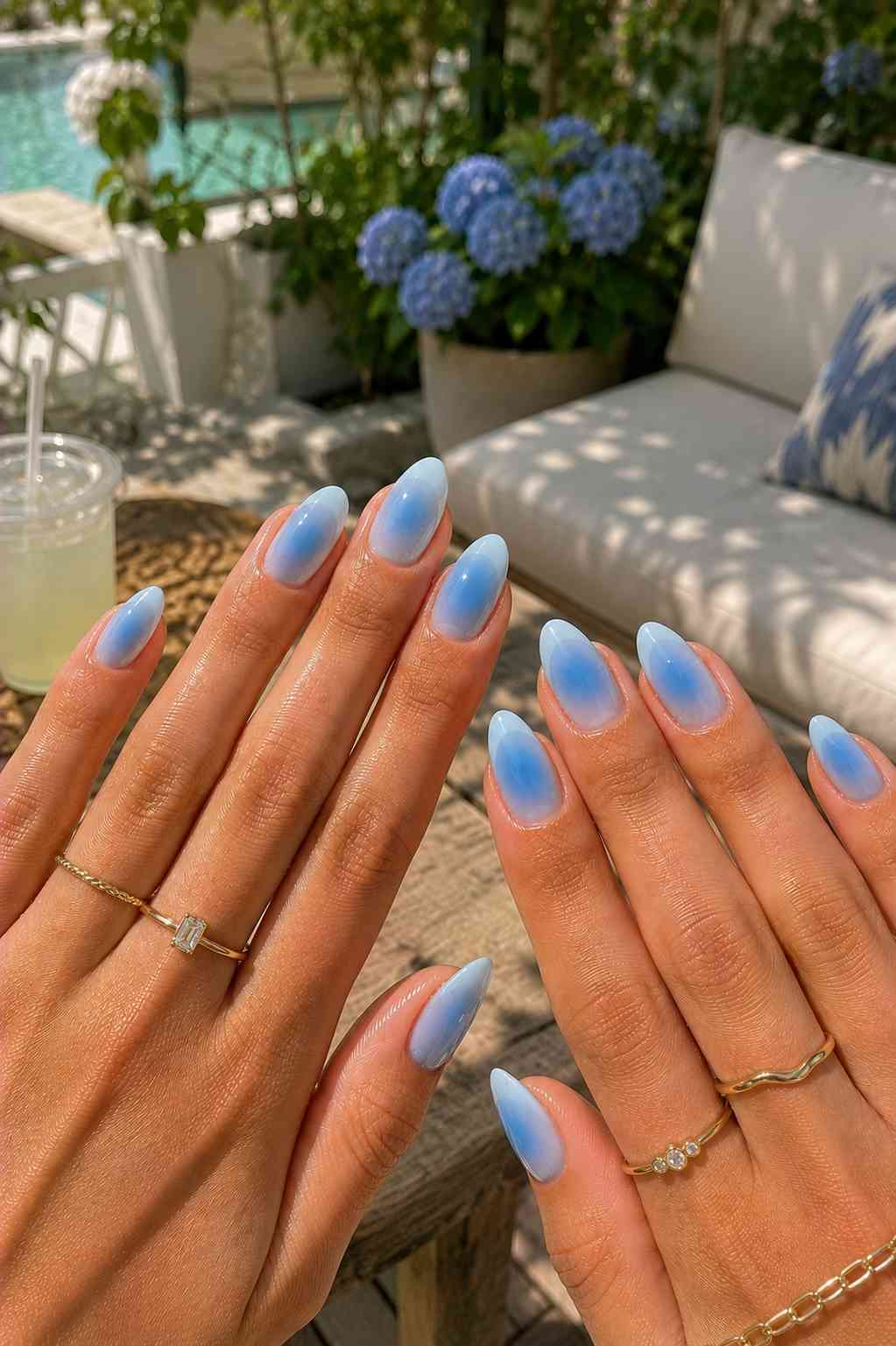 Almond nails with a soft blue aura effect fading from the center toward the edges
