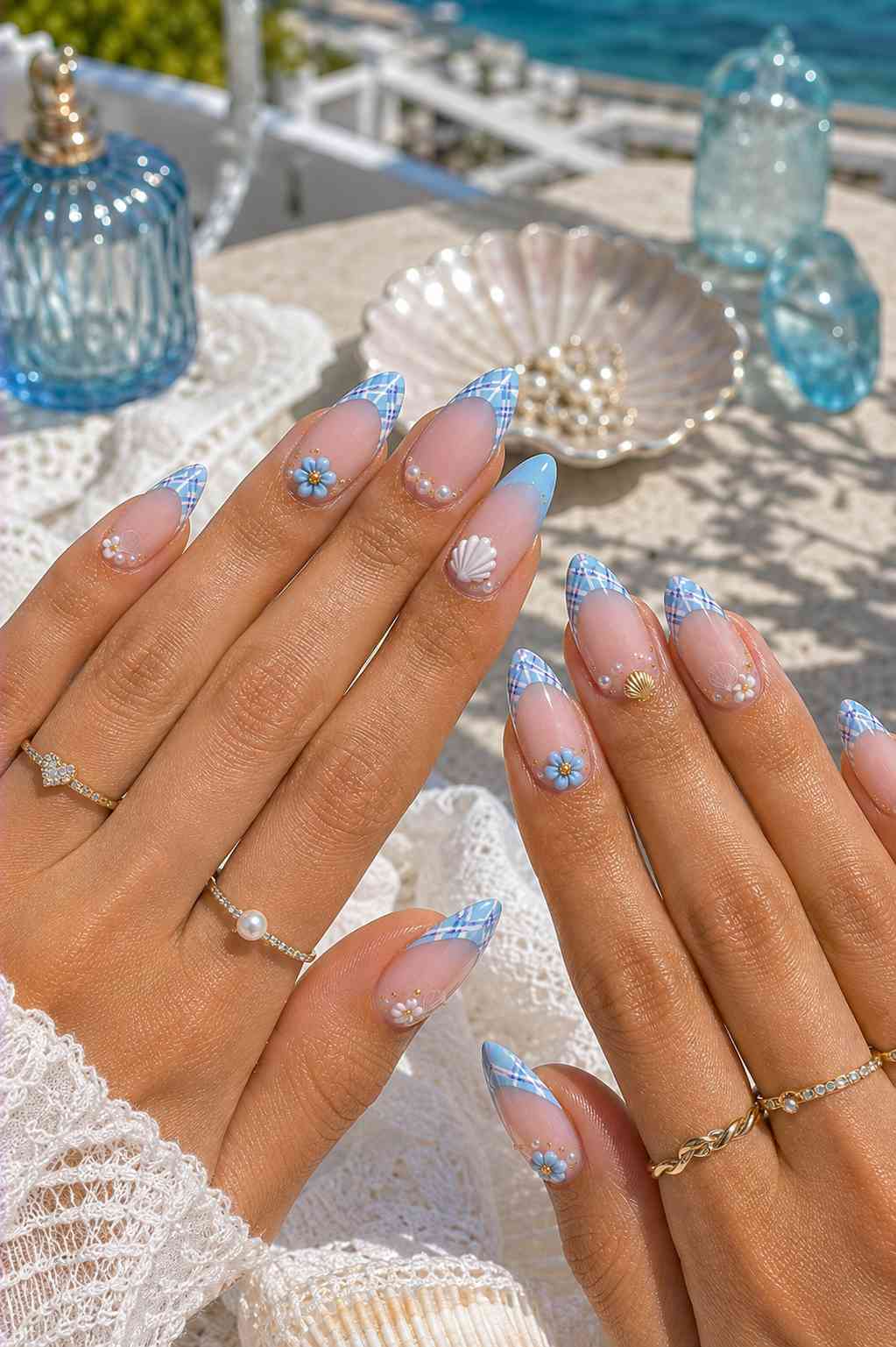 Blue plaid French tip nails with 3D daisies, pearls, and small gold shell charms