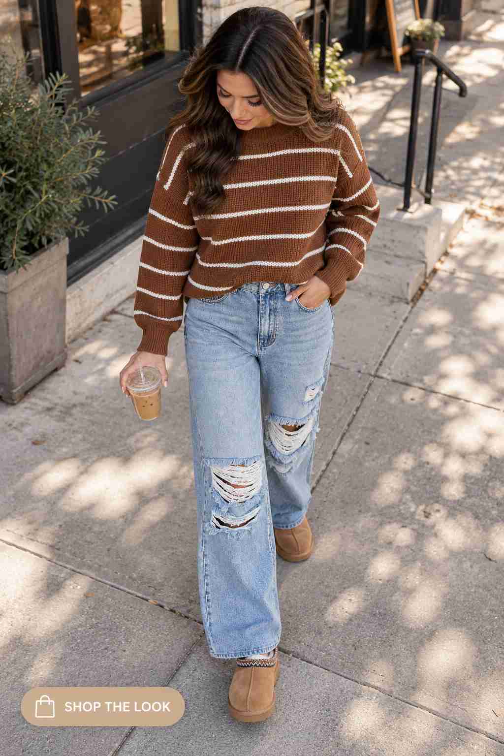 Brown and cream striped sweater with distressed wide-leg jeans and suede boots