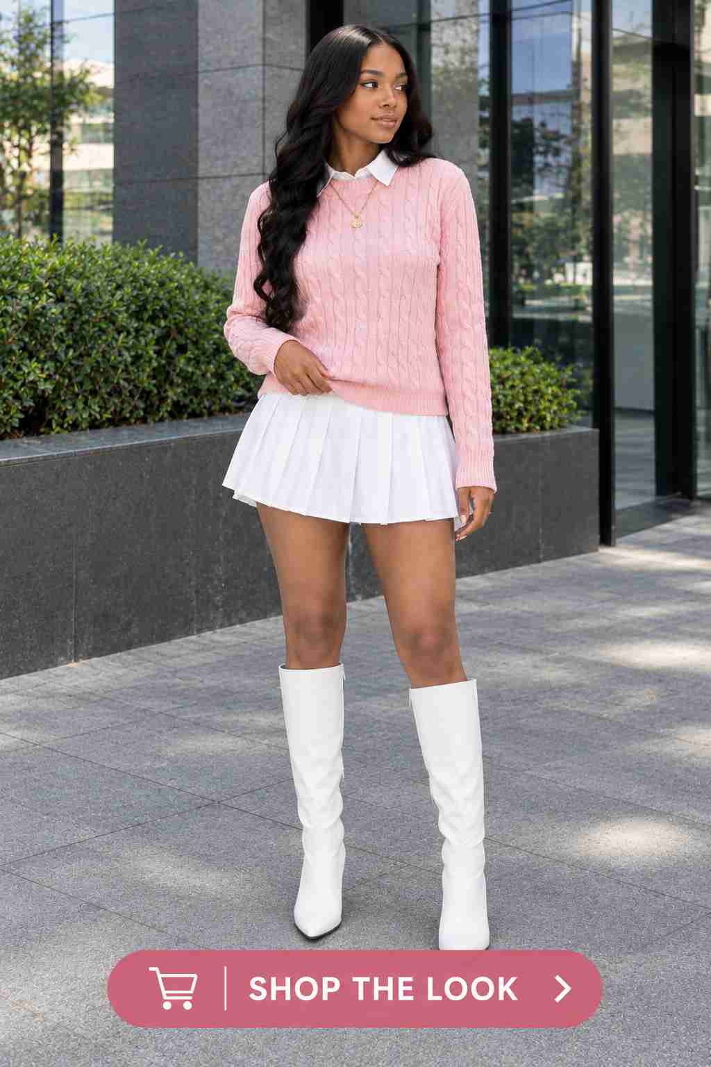 Woman in pink cable knit sweater with white pleated mini skirt and suede clogs