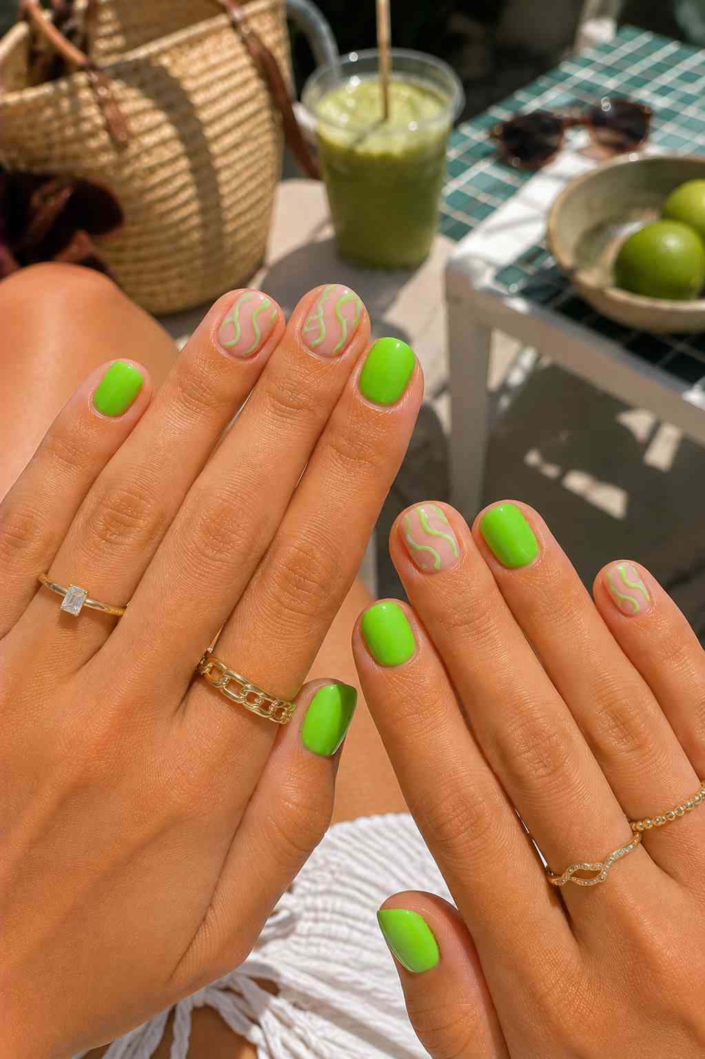 Bright neon green nails with sheer accent nails featuring green squiggle line art