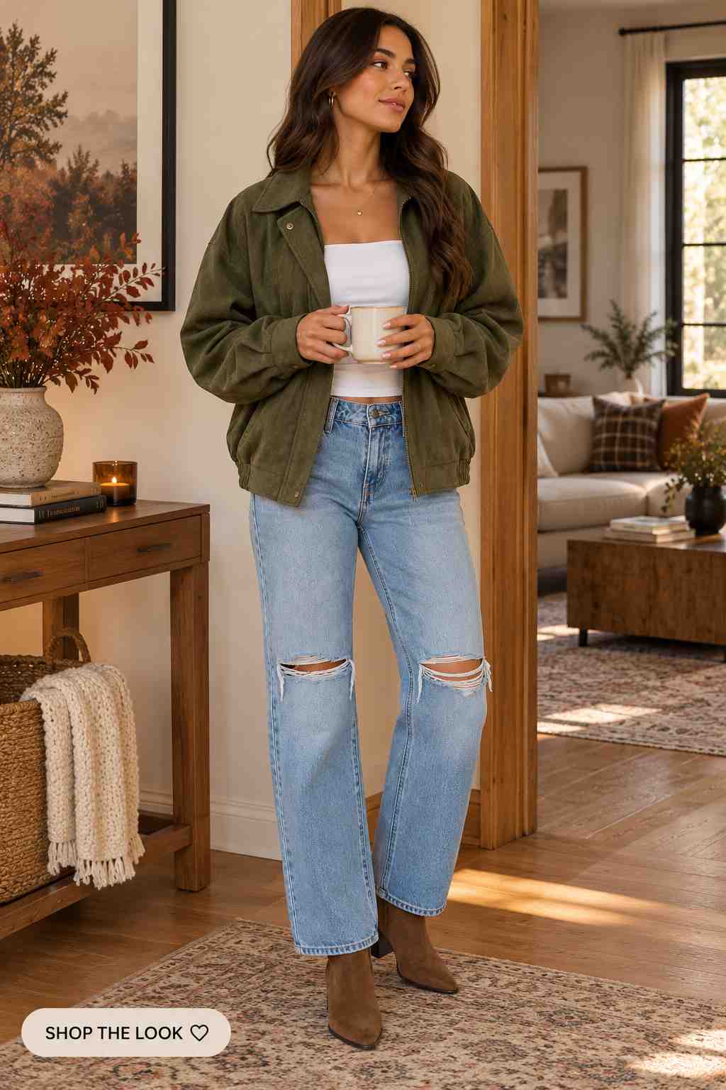 Olive suede jacket over a white top with ripped wide-leg jeans and ankle boots