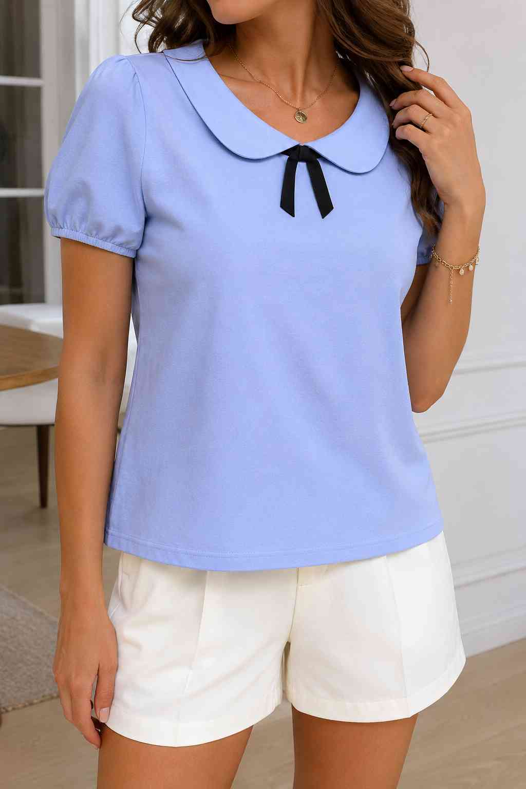 Periwinkle blue top with Peter Pan collar and black bow detail, styled with white shorts