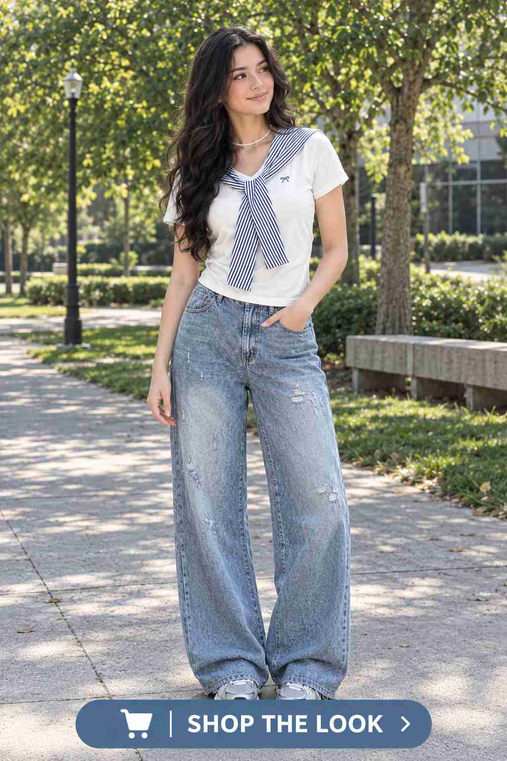 Woman in white tee with striped bow tie scarf and distressed wide-leg jeans
