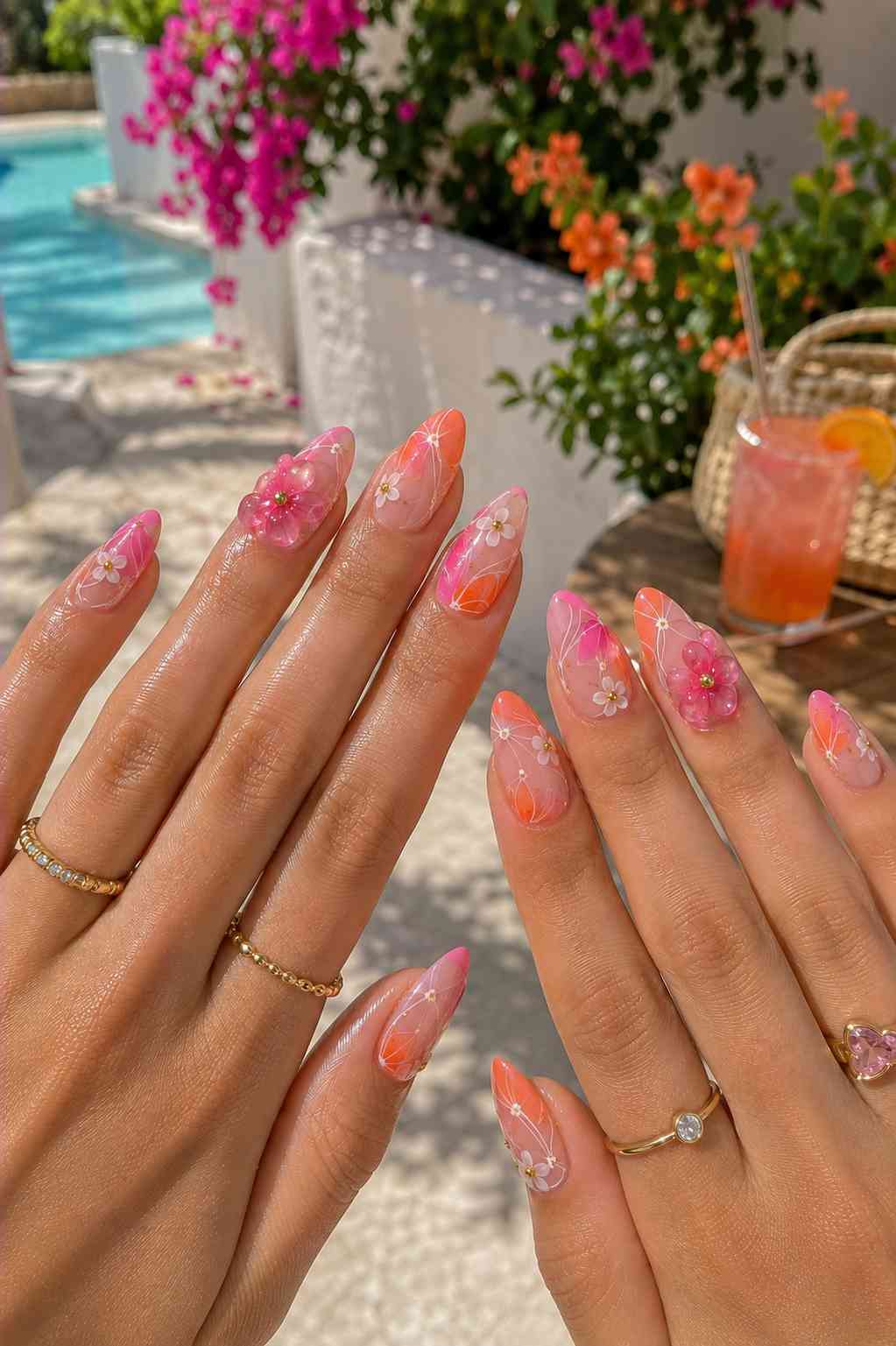 Pink and orange ombre almond nails with fine white vine line art and a 3D flower accent