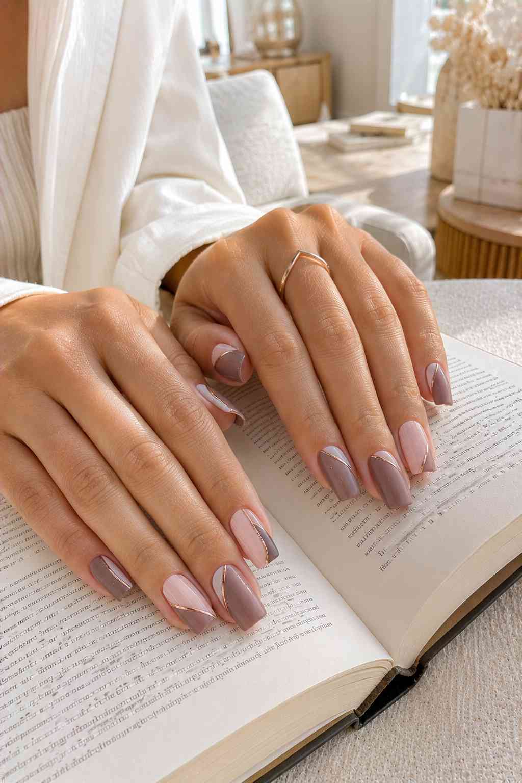 Taupe and blush pink nails with thin diagonal gold line accents