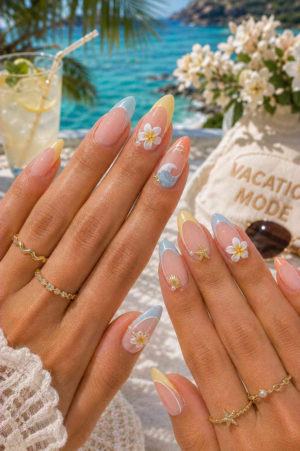 Pastel blue, yellow, and coral French tip nails with 3D white plumeria flowers, a starfish, and a shell charm